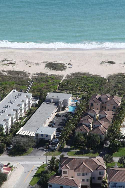 View of hotel, pool, and beach in the background