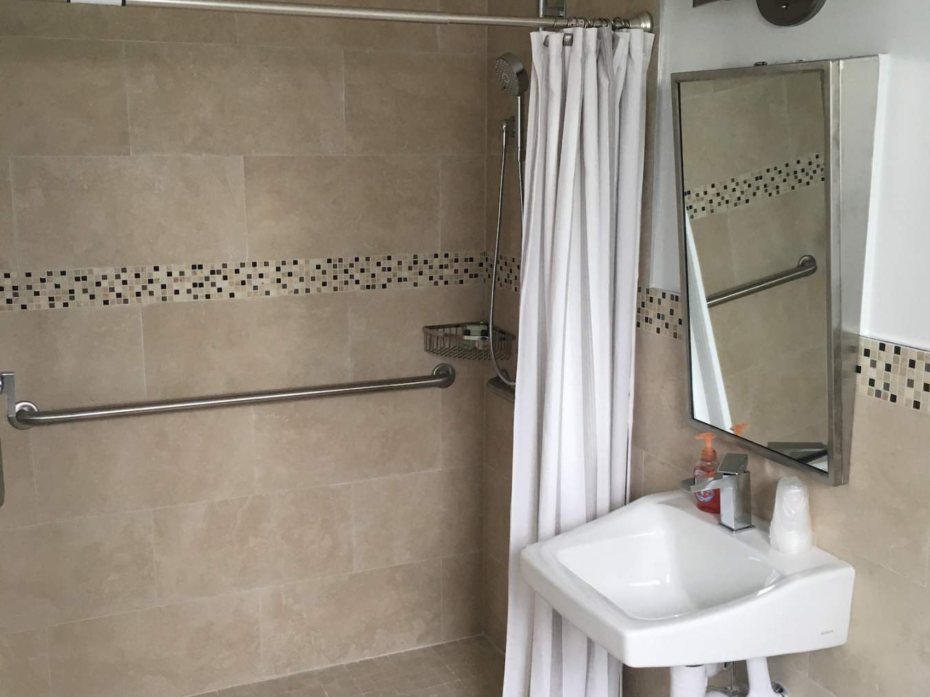 Shower with sink and mirror on the right