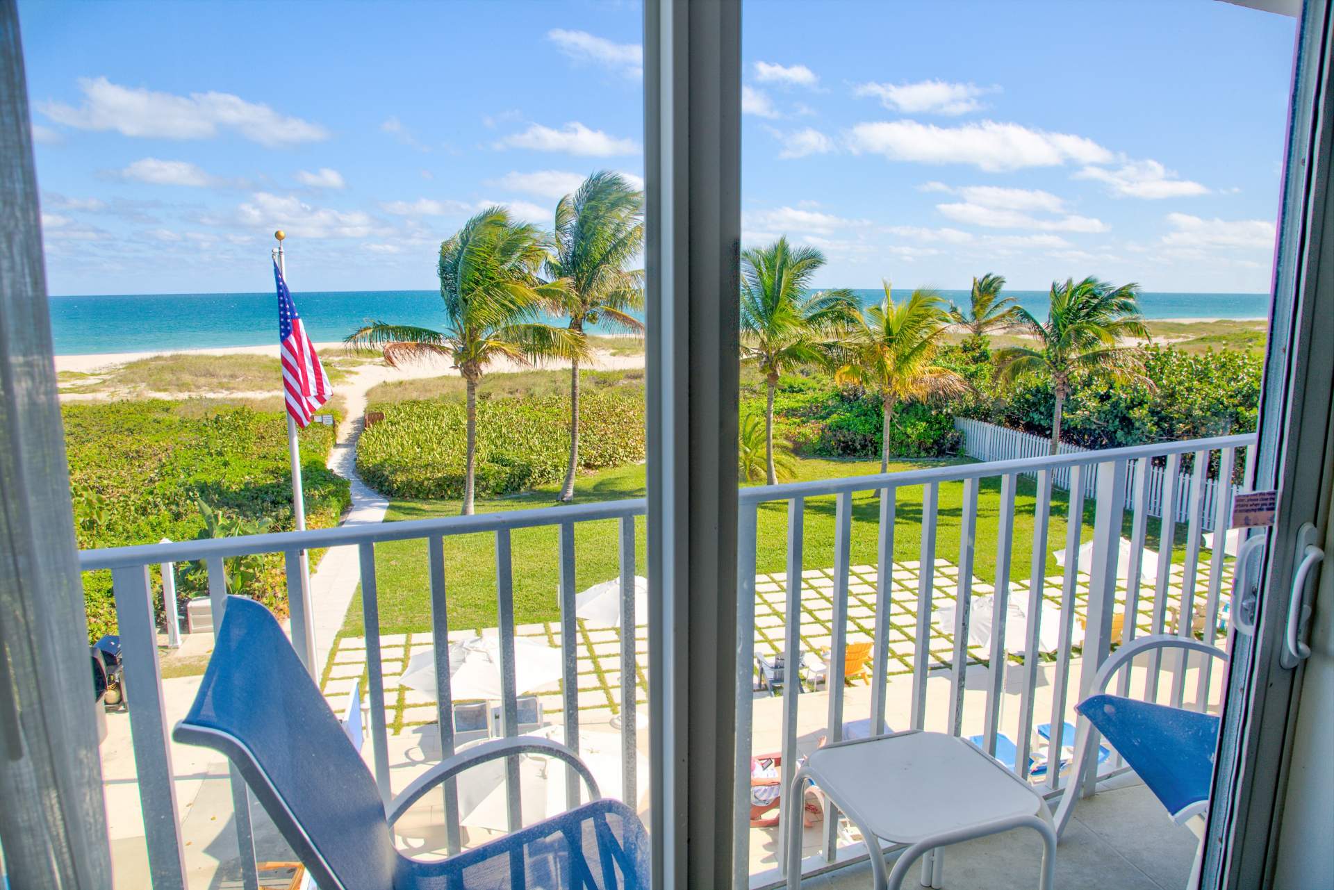 View of the outdoors with palm trees and American flag